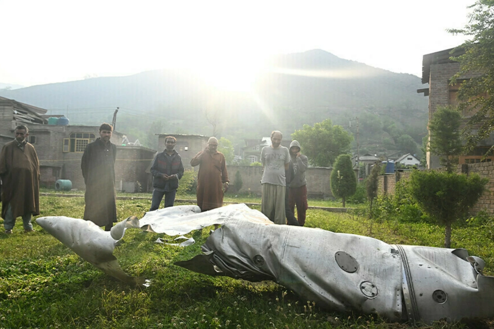 people look at a part of an aircraft in wuyan near indian illegally occupied kashmir s main city of srinagar on may 7 2025 photo afp people look at a part of an aircraft in wuyan near indian illegally occupied kashmir s main city of srinagar on may 7 2025 photo afp