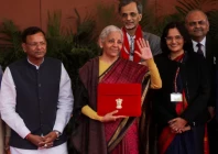india s finance minister nirmala sitharaman waves as she holds a folder bearing the government of india s emblem while posing with her officials before leaving her office to present the annual federal budget in parliament in new delhi india february 1 photo reuters