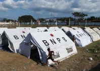 children run next to shelters at a makeshift evacuation centre at a stadium in the aftermath of an earthquake in maumere east nusa tenggara indonesia august 16 2026 photo reuters