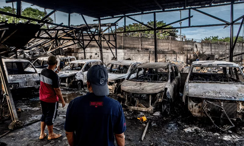 two men look at burnt cars in plumpang north jakarta on march 4 2023 after a fire at a nearby state run fuel storage depot run by energy firm pertamina photo afp two men look at burnt cars in plumpang north jakarta on march 4 2023 after a fire at a nearby state run fuel storage depot run by energy firm pertamina photo afp