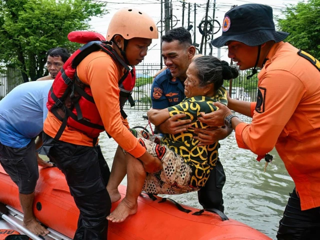 rescuers evacuate an elderly person using a rubber boat during the flood in medan north sumatra on november 28 2025 photo afp