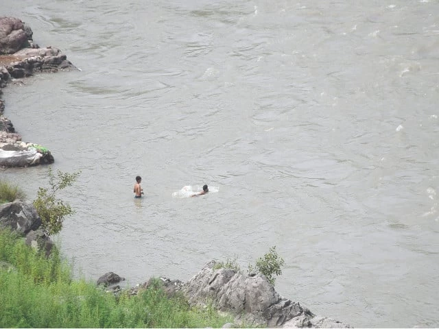 as monsoon rains swell rivers and floods loom large young boys take a reckless plunge in the jhelum river near muzaffarabad highlighting parental negligence and the local administration s turning a blind eye to safety concerns photo online as monsoon rains swell rivers and floods loom large young boys take a reckless plunge in the jhelum river near muzaffarabad highlighting parental negligence and the local administration s turning a blind eye to safety concerns photo online