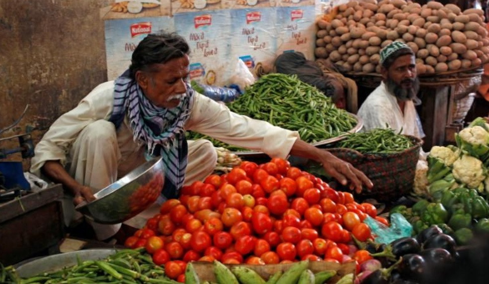 man sells vegetables at the empress market in karachi pakistan photo reuters