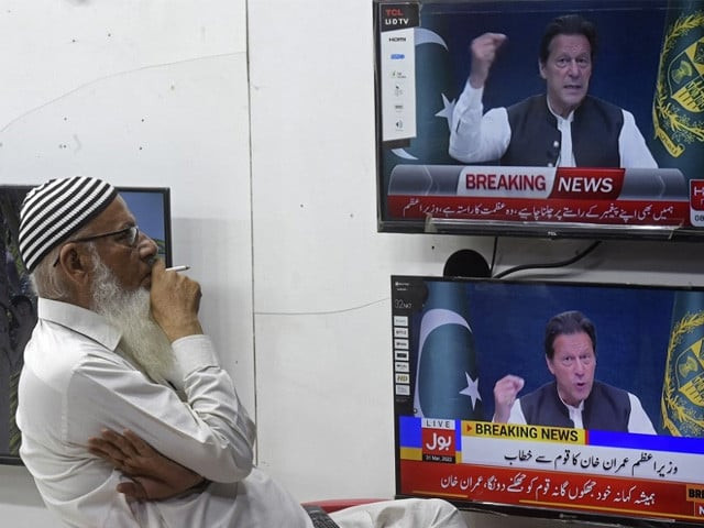 a man listens to pakistan s prime minister imran khan addressing the nation on television at a market in karachi march 31 2022 photo afp a man listens to pakistan s prime minister imran khan addressing the nation on television at a market in karachi march 31 2022 photo afp