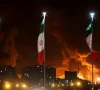 iranian flags fly as fire and smoke from an israeli attack on sharan oil depot rise following israeli strikes on iran in tehran iran photo reuters