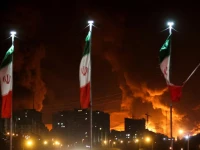 iranian flags fly as fire and smoke from an israeli attack on sharan oil depot rise following israeli strikes on iran in tehran iran photo reuters