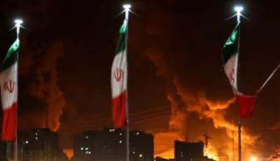 iranian flags fly as fire and smoke from an israeli attack on sharan oil depot rise following israeli strikes on iran in tehran iran photo reuters