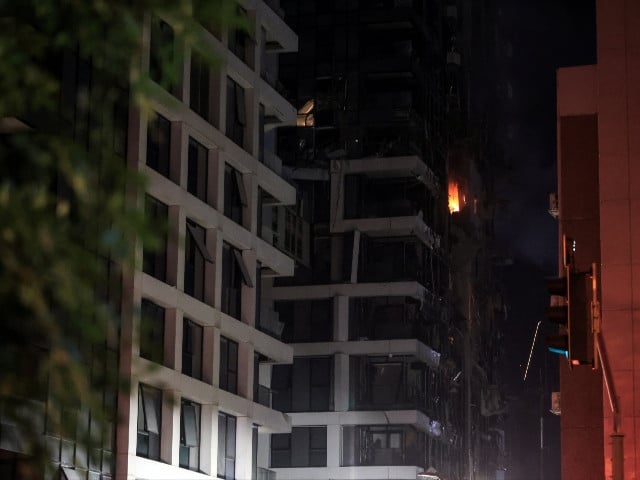 Fire burns in a building at an impact site following a missile attack from Iran on Israel, at Tel Aviv, Israel,   June 13, 2025. Photo: Reuters
