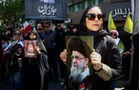 a woman holds a picture of late supreme leader of iran ayatollah ali khamenei during a ceremony in tehran iran 9 april 2026 photo reuters