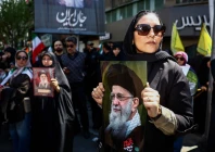 a woman holds a picture of late supreme leader of iran ayatollah ali khamenei during a ceremony in tehran iran 9 april 2026 photo reuters