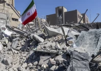 an iranian flag is planted in the rubble of a police station damaged in airstrikes in tehran iran photo reuters