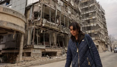 a woman walks on the street following an israeli and u s strike on gandhi hotel hospital amid the u s  israel conflict with iran in tehran iran march 2 2026