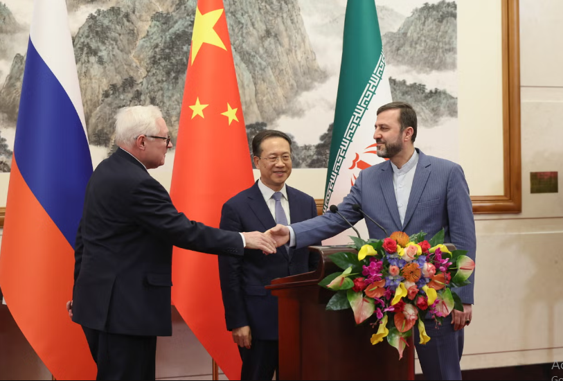 russia s deputy foreign minister sergei ryabkov left with china s vice foreign minister ma zhaoxu and iran s deputy foreign minister kazem gharibabadi hold a press conference after their meeting in beijing on 14 march 2025 photo getty images