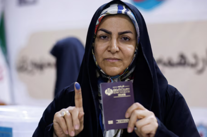 a woman shows her inked finger after voting in a snap presidential election to choose a successor to ebrahim raisi following his death in a helicopter crash at the iranian consulate in najaf iraq june 28 2024 photo reuters