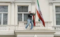 protester removes iran s flag in london