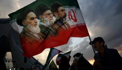 a man holds a flag with a picture of late leader of the islamic revolution ayatollah ruhollah khomeini late supreme leader of iran ayatollah ali khamenei and iran s new supreme leader mojtaba khamenei during a rally in tehran iran april 29 2026 photo reuters file