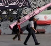 people walk next to a symbolic mockup of an iranian missile and an iranian flag at imam hussein square in tehran iran july 12 2026 majid asgaripour wana via reporters