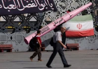 people walk next to a symbolic mockup of an iranian missile and an iranian flag at imam hussein square in tehran iran july 12 2026 majid asgaripour wana via reporters