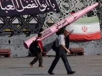 people walk next to a symbolic mockup of an iranian missile and an iranian flag at imam hussein square in tehran iran july 12 2026 majid asgaripour wana via reporters