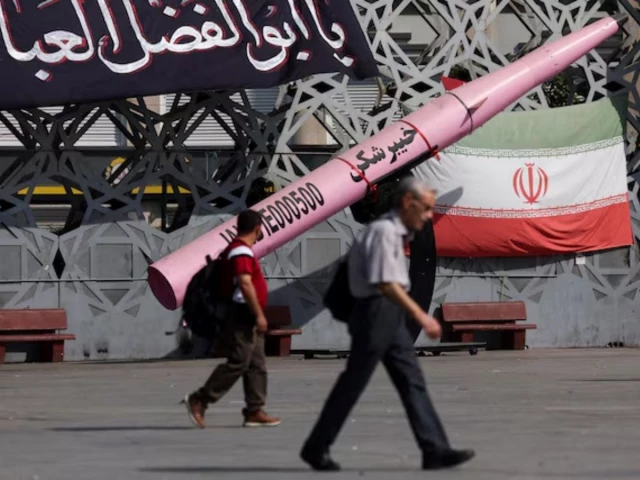 people walk next to a symbolic mockup of an iranian missile and an iranian flag at imam hussein square in tehran iran july 12 2026 majid asgaripour wana via reporters people walk next to a symbolic mockup of an iranian missile and an iranian flag at imam hussein square in tehran iran july 12 2026 majid asgaripour wana via reporters