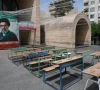 a banner with a picture of iran s new supreme leader mojtaba khamenei next to a symbolic classroom of the minab school students who were killed in a strike in tehran iran may 8 2026 photo reuters