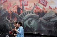 people walk past an anti u s billboard on a street in tehran iran august 3 2026 majid asgaripour wana west asia news agency via reuters