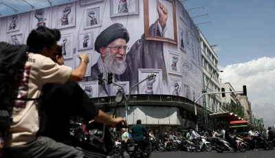 people ride motorcycles near a billboard featuring an image of the late supreme leader of iran ayatollah ali khamenei in tehran iran may 6 2026 photo reuters
