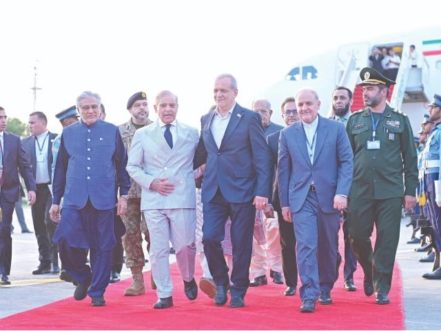 prime minister shehbaz sharif walks alongside iran s president masoud pezeshkian and his entourage upon their arrival in islamabad photo app