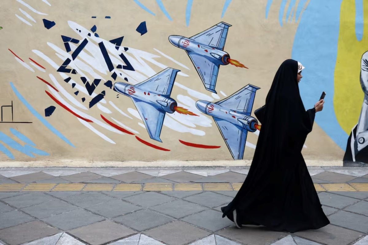 A woman walks next to an anti-Israeli mural on a street, amid a ceasefire between U.S. and Iran, in Tehran, Iran, April 20, 2026.REUTERS
