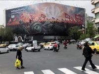 people walk past an anti u s billboard on a street in tehran iran august 3 2026 photo reuters