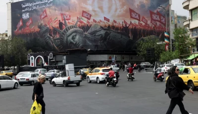 people walk past an anti u s billboard on a street in tehran iran august 3 2026 photo reuters