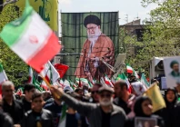 people carry a banner with an image of late supreme leader of iran ayatollah ali khamenei during the ceremony in tehran reuters