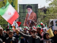 people carry a banner with an image of late supreme leader of iran ayatollah ali khamenei during the ceremony in tehran reuters