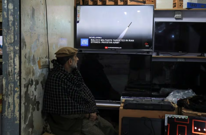 a man watches a news channel on television inside a shop after the pakistani foreign ministry said the country conducted strikes inside iran targeting separatist militants two days after tehran said it attacked israel linked militant bases inside pakistani territory in peshawar pakistan january 18 2024 reuters fayaz aziz