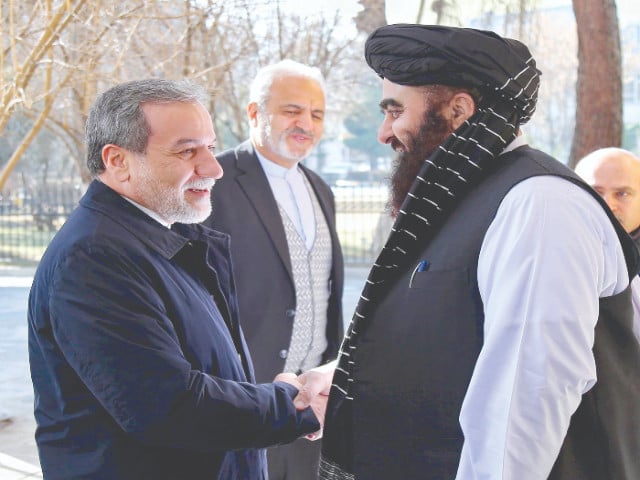 afghanistan s minister of foreign affairs amir khan muttaqi shakes hands with his iranian counterpart abbas araghchi at the foreign ministry in kabul photo afp ministry of foreign affairs of afghanistan