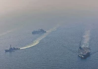 nimitz class aircraft carrier uss abraham lincoln cvn 72 sails alongside arleigh burke class guided missile destroyer uss frank e petersen jr ddg 121 in the arabian sea photo afp