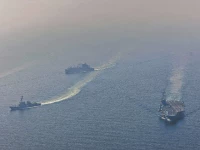 nimitz class aircraft carrier uss abraham lincoln cvn 72 sails alongside arleigh burke class guided missile destroyer uss frank e petersen jr ddg 121 in the arabian sea photo afp file