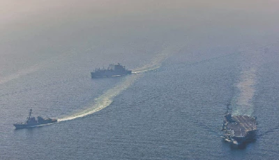 nimitz class aircraft carrier uss abraham lincoln cvn 72 sails alongside arleigh burke class guided missile destroyer uss frank e petersen jr ddg 121 in the arabian sea photo afp