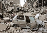 a destroyed vehicle amid rubble at the site of a strike on a residential building amid the us israeli conflict with iran in tehran iran march 16 2026 reuters