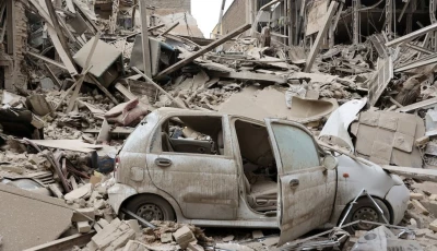 a destroyed vehicle amid rubble at the site of a strike on a residential building amid the us israeli conflict with iran in tehran iran march 16 2026 reuters