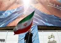 a man holds an iranian flag near an anti us billboard depicting us president donald trump and the strait of hormuz in tehran iran on may 2 2026 photo reuters