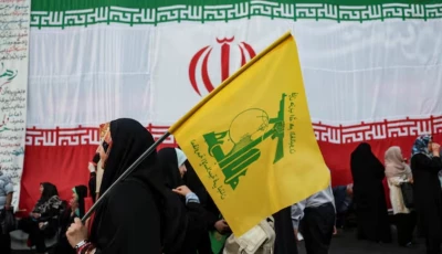 a woman holds a hezbollah flag during a rally in support of iran s supreme leader mojtaba khamenei in tehran iran on june 4 2026 west asia news agency via reuters