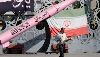 a man walks next to a symbolic mockup of an iranian missile and an iranian flag at imam hussein square in tehran iran july 12 2026 photo reuters a man walks next to a symbolic mockup of an iranian missile and an iranian flag at imam hussein square in tehran iran july 12 2026 photo reuters