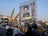 iranian missiles are displayed next to a banner with a picture of iran s supreme leader mojtaba khamenei on a street in tehran photo reuters