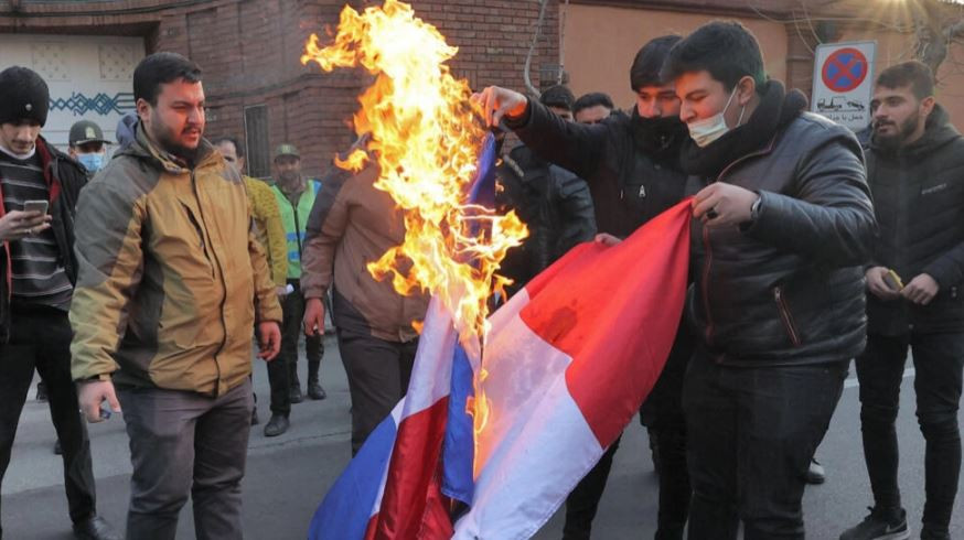 demonstrators burn a french flag during a protest against cartoons of the islamic republic s supreme leader ayatollah ali khamenei published by french satirical weekly charlie hebdo outside the french embassy in iran s capital tehran on january 8 2023 photo afp