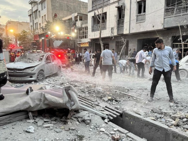 people and first responders gather outside a that was hit by an israeli strike in tehran iran june 13 2025 photo afp people and first responders gather outside a that was hit by an israeli strike in tehran iran june 13 2025 photo afp