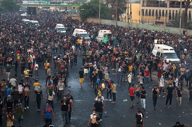 Iraqi protesters gather during a demonstration against state corruption, failing public services and unemployment at Tayaran square in Baghdad (Photo: AFP)