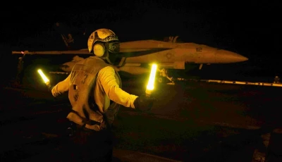 us sailor signaling an f a 18e super hornet on the flight deck of nimitz class aircraft carrier uss george hw bush on july 21 2026 in us navy handout photograph released on july 28 2026 by us central command public affairs photo afp