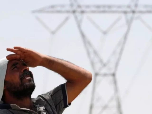 an iraqi man stands under an electricity transmission tower south of the city of hillah on august 10 2025 ahmad al rubaye photo afp an iraqi man stands under an electricity transmission tower south of the city of hillah on august 10 2025 ahmad al rubaye photo afp