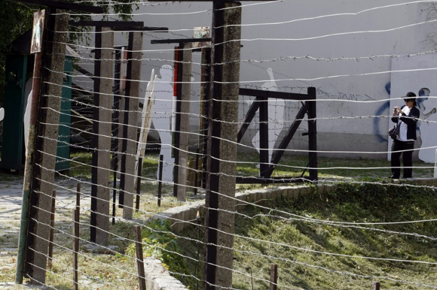 A visitor takes a picture of a section of the wall on display at Sopron on the Hungarian-Austrian border. PHOTO: AFP